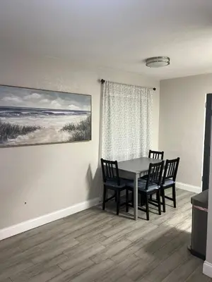 a dining room with a table and chairs and a window at City and Stadium Sanctuary Vibes in Orlando