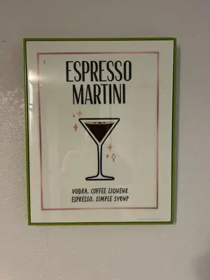 a sign for a martini hanging on a wall at City and Stadium Sanctuary Vibes in Orlando