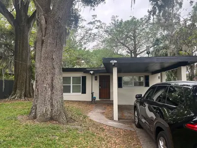 a house with a car parked in front of it at City and Stadium Sanctuary Vibes in Orlando