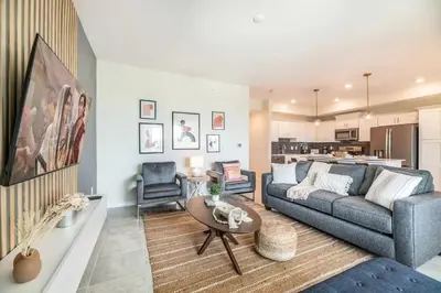 a living room with a couch and a table at Apartamento Moderno 2Q | Quarto Temático do Mickey in Kissimmee