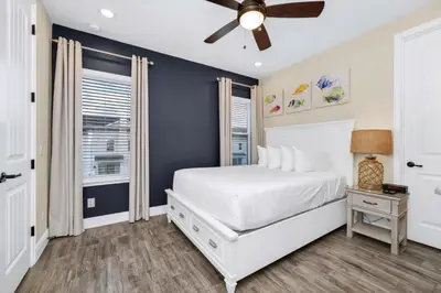 a bedroom with a white bed and a ceiling fan at Comfy Villa Near Disney With Margaritaville Resort & Island H20 Access - 8155Cp in Orlando