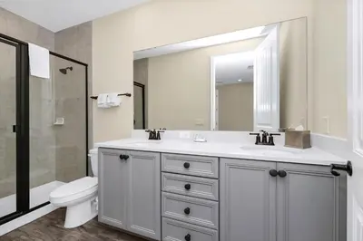a bathroom with a sink and a toilet and a mirror at Comfy Villa Near Disney With Margaritaville Resort & Island H20 Access - 8155Cp in Orlando