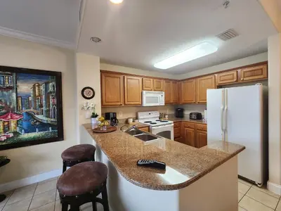a kitchen with a counter top and a refrigerator at Orlando 1st Floor - 5 min Disney in Orlando