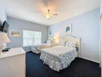 a bedroom with two beds and a ceiling fan at Two Bedroom Condo near Disney condo in Kissimmee