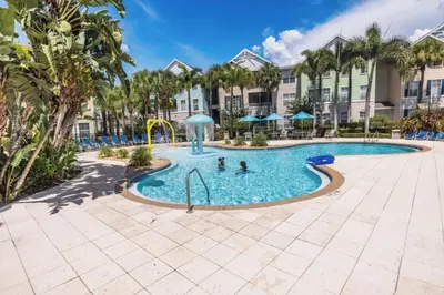 a pool at a resort with people playing in it at Two Bedroom Condo near Disney condo in Kissimmee