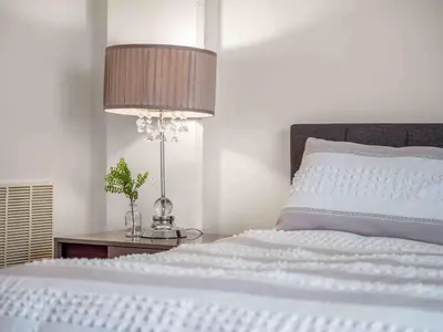 a bedroom with a bed with a lamp and a table at PentHouse Downtown Orlando 2 Beds 2 baths in Orlando