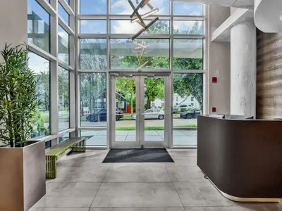 an office lobby with large windows and a reception desk at Luxurious 2 Beds 2 Baths Downtown Apartment in Orlando