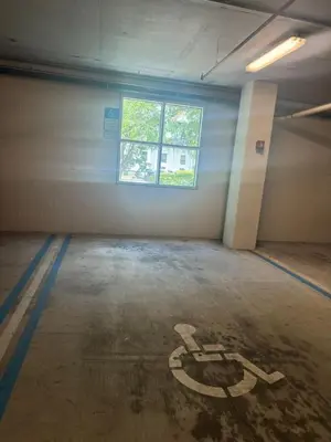 an empty parking garage with a sign on the floor at Luxurious 2 Beds 2 Baths Downtown Apartment in Orlando