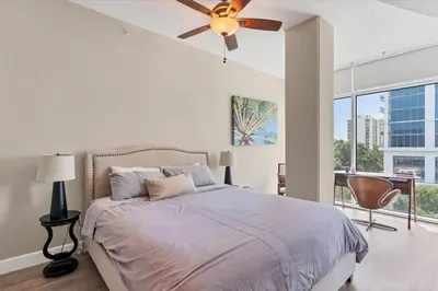 a bedroom with a bed and a ceiling fan at Beautiful Downtown Condo 1 Bed 1 Bath in Orlando