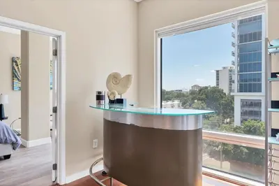a bar in a room with a large window at Beautiful Downtown Condo 1 Bed 1 Bath in Orlando
