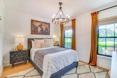 a bedroom with a bed and a chandelier at Near Parks and Lakes Sorrento Home with Pool and Yard! in Sorrento