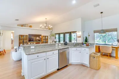 a kitchen with white cabinets and a large counter top at Near Parks and Lakes Sorrento Home with Pool and Yard! in Sorrento