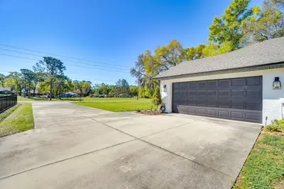 a house with a garage with a driveway at Near Parks and Lakes Sorrento Home with Pool and Yard! in Sorrento