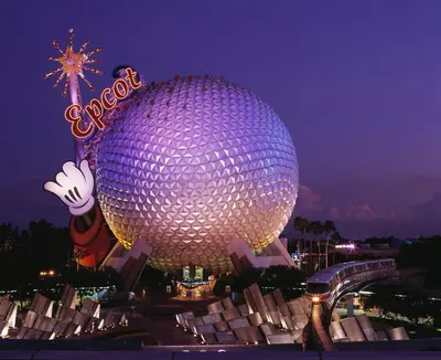 a large purple building with a sign on it at night at Modern- 2 Queen bed suite with pool near Disney World in Kissimmee