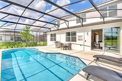 a large swimming pool with a glass ceiling at Family Home with Cinema Pool and BBQ Near Disney in Kissimmee