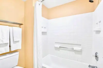 a bathroom with a white tub and a toilet at Chic 1BR Suite w Pool Hot Tub & BBQ Near Disney in Orlando