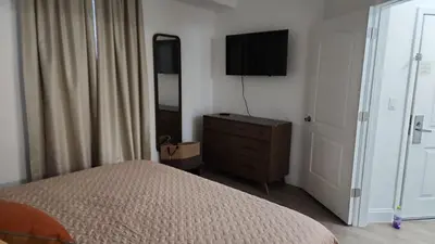 a bedroom with a bed and a dresser with a television at Orlando Blue Heron 1 Mile From Disney 11th floor in Orlando
