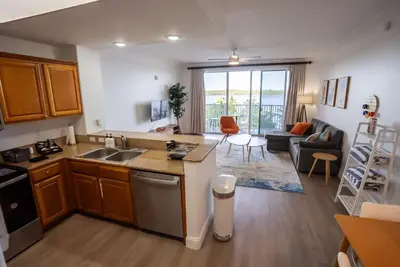a kitchen and living room with a sink and a couch at Orlando Blue Heron 1 Mile From Disney 11th floor in Orlando