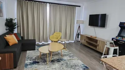 a living room with a couch and chairs and a tv at Orlando Blue Heron 1 Mile From Disney 11th floor in Orlando