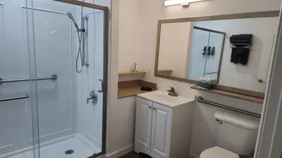 a bathroom with a shower and a sink and a mirror at Orlando Blue Heron 1 Mile From Disney 11th floor in Orlando