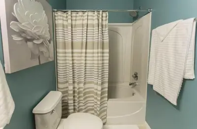 a bathroom with a white toilet and a shower at Magic Starts Here! Minutes to Disney Land in Orlando