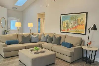 a living room with a couch and a table at Disney-Area 4BR | Pool + Patio in Kissimmee