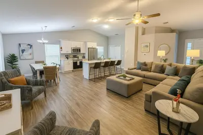 a living room with a couch and a table at Disney-Area 4BR | Pool + Patio in Kissimmee