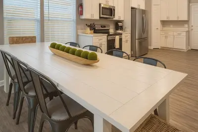 a kitchen with a table with a bowl of fruit on it at Disney-Area 4BR | Pool + Patio in Kissimmee
