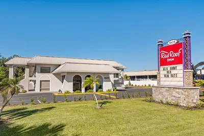 a coca cola sign in front of a building at Red Roof Inn Kissimmee, FL in Kissimmee