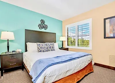 a bedroom with a large bed and a window at King Suite w BBQ & Games Room - Sand Lake in Orlando