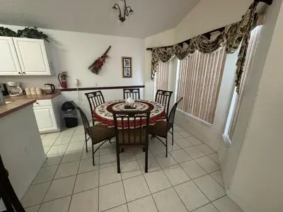 a dining room table and chairs in a kitchen at Sunset Villa – Your Gateway to a Magical Florida Vacation! in Kissimmee