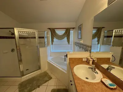 a bathroom with a sink and a shower and a tub at Sunset Villa – Your Gateway to a Magical Florida Vacation! in Kissimmee
