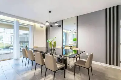 a dining room with a glass table and chairs at FLASH SALE Pvt Pool and Spa Home at Storey Lake in Kissimmee