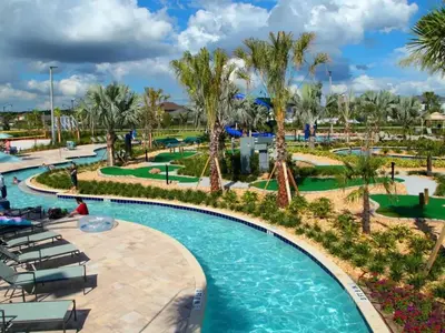 a pool at a resort with palm trees and chairs at FLASH SALE Pvt Pool and Spa Home at Storey Lake in Kissimmee