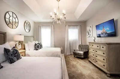 a bedroom with two beds and a chandelier at Flash 20 Off Gorgeous Vacation Home near Everywhere in Kissimmee