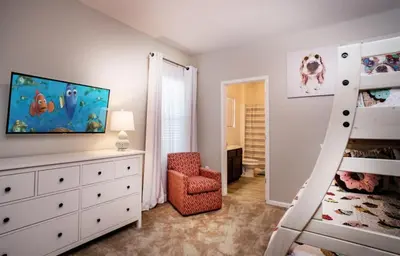 a childs bedroom with a bunk bed and a ladder at Flash 20 Off Gorgeous Vacation Home near Everywhere in Kissimmee