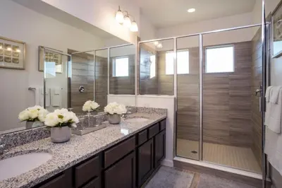a bathroom with two sinks and a shower at Flash 20 Off Gorgeous Vacation Home near Everywhere in Kissimmee