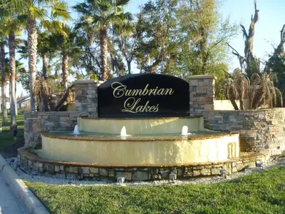 a sign for a fountain in a park with palm trees at Charming 4-Bedroom Villa with Pool & Spa, Only 15 Minutes from Disney! in Kissimmee