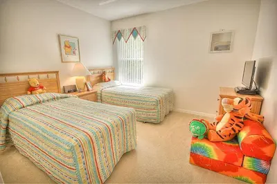 a childs bedroom with two beds and a toy at Charming 4-Bedroom Villa with Pool & Spa, Only 15 Minutes from Disney! in Kissimmee