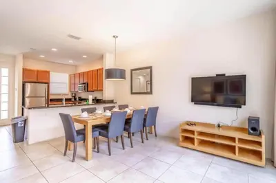 a kitchen and dining room with a table and chairs at Flash 20 Off Private Spa Townhome at Regal Oaks Resort in Orlando