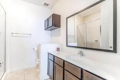 a bathroom with a sink and a mirror at Flash 20 Off Private Spa Townhome at Regal Oaks Resort in Orlando