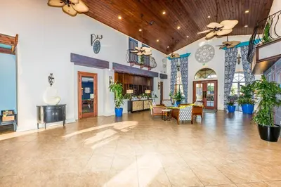 a lobby with a table and chairs and plants at Flash 20 Off Spetacular TownHome With Private Pool close to Disney 8919PP in Kissimmee