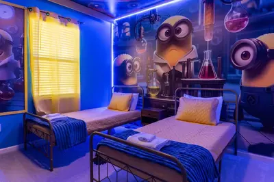a room with two beds in a room with a wall filled with monsters at Sophisticated 9 bedroom close to Disney in Kissimmee