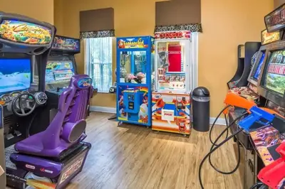 a room with arcade games and video games at Flash 20 Off Townhome at Emerald Island Resort in Kissimmee