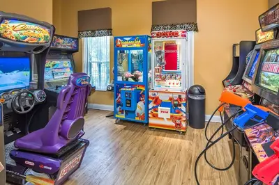 a room with arcade games and video games at Flash 20 Off Townhome at Emerald Island in Kissimmee