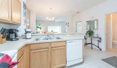 a kitchen with a sink and a counter top at Flash 20 Off Townhome at Emerald Island in Kissimmee