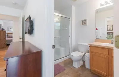 a bathroom with a toilet and a sink and a shower at Flash 20 Off Townhome at Emerald Island in Kissimmee