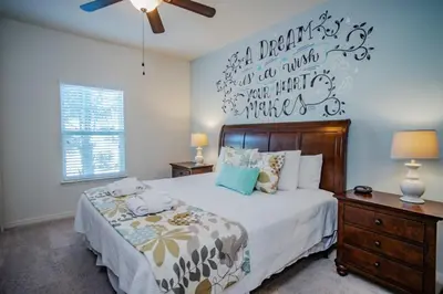 a bedroom with a bed and a wall with writing on it at Special Offer Cozy Townhome at West Lucaya in Kissimmee