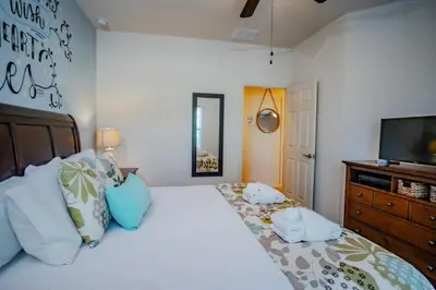 a bedroom with a large bed with a television on it at Special Offer Cozy Townhome at West Lucaya in Kissimmee