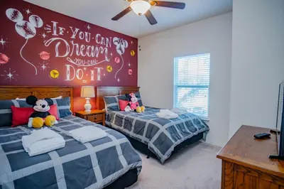 a bedroom with two beds and a wall that says if you can dream you can at Special Offer Cozy Townhome at West Lucaya in Kissimmee